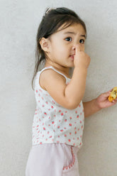 Toddler girl in Avauma strawberry cream sleeveless top and lilac shorts – sweet summer outfit
